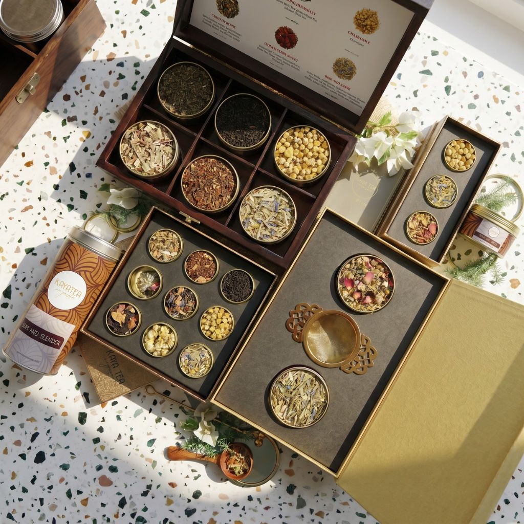 Kaya Tea Organic gift hamper with tins, sachets, and a gold strainer